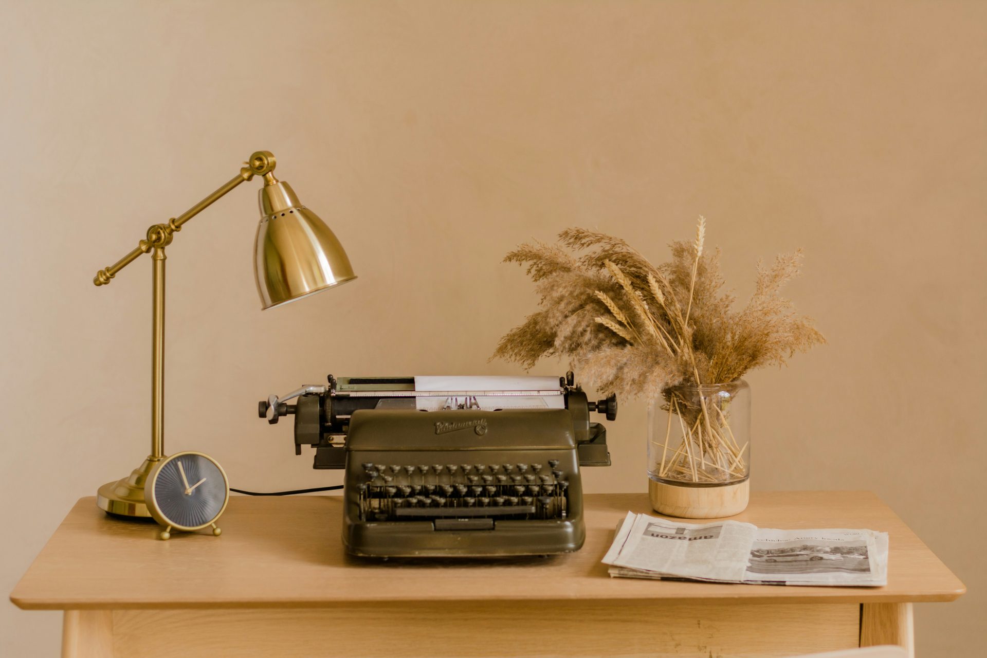 a typewriter and a lamp on a desk